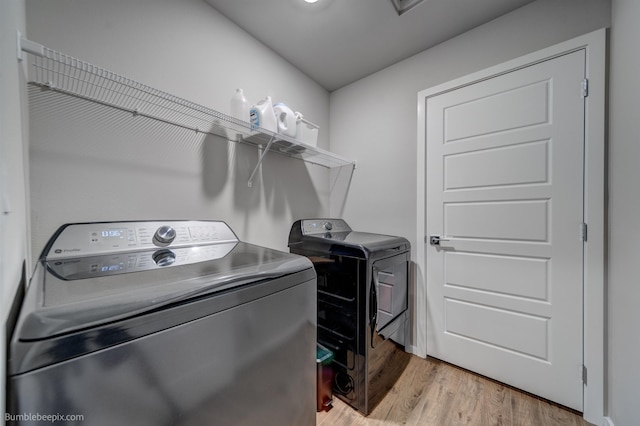 3640 S Clinton Rd, Spokane Valley, WA 99206 - washroom featuring washing machine and dryer and light wood-style flooring