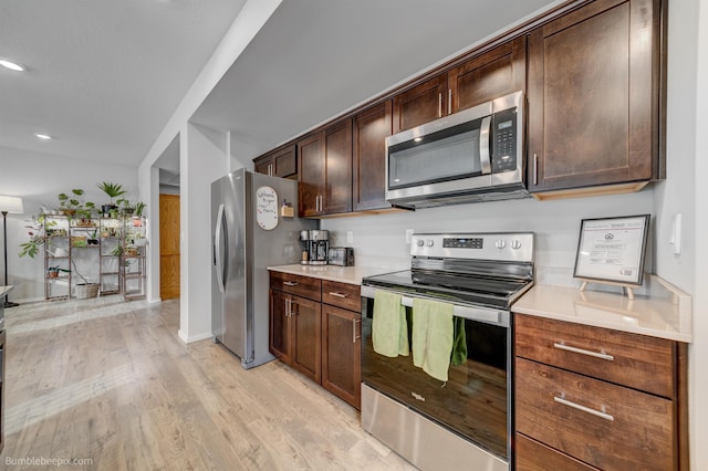 3640 S Clinton Rd, Spokane Valley, WA 99206 - kitchen with stainless steel appliances, light wood-type flooring, dark brown cabinetry, light countertops, and recessed lighting
