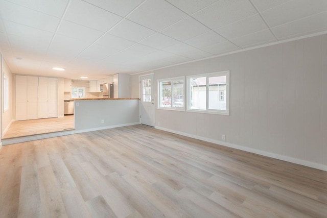 105 E Aspen Ave, Springdale, WA 99173 - unfurnished living room with light wood-type flooring and a paneled ceiling
