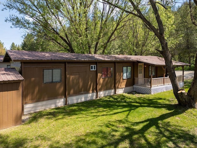 105 E Aspen Ave, Springdale, WA 99173 - back of house with a porch, a lawn, and a metal roof