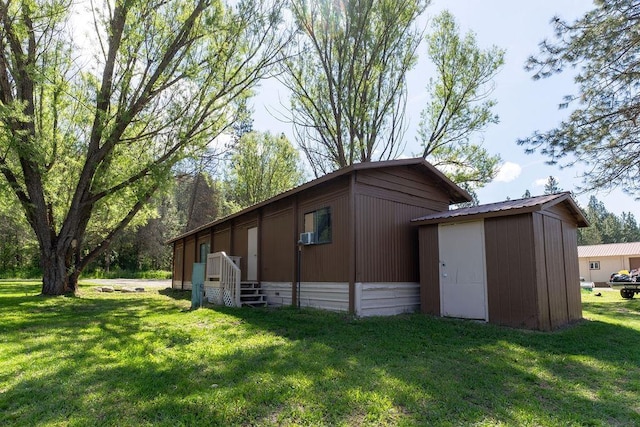 105 E Aspen Ave, Springdale, WA 99173 - view of home's exterior with a yard, a metal roof, and a storage unit