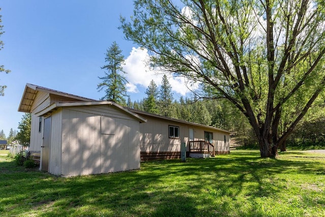 105 E Aspen Ave, Springdale, WA 99173 - view of home's exterior featuring a deck and a lawn