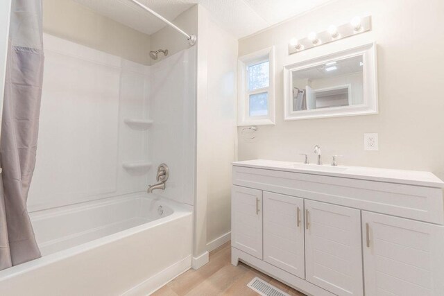 105 E Aspen Ave, Springdale, WA 99173 - bathroom featuring shower / tub combo with curtain, wood finished floors, and vanity