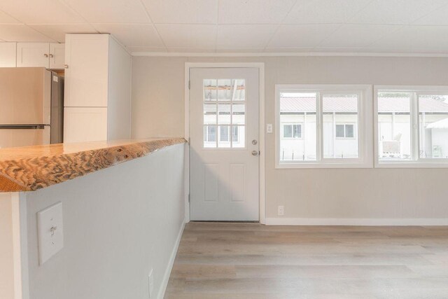 105 E Aspen Ave, Springdale, WA 99173 - doorway with light wood finished floors and baseboards