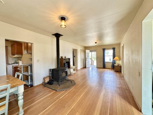 521 N Ramsey St, Tekoa, WA 99033 - living area featuring a wood stove and light wood-style flooring