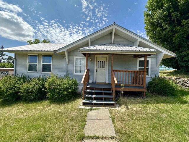 521 N Ramsey St, Tekoa, WA 99033 - view of front of house featuring a front yard, covered porch, and a metal roof