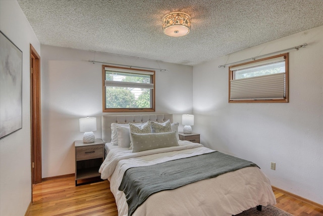 3308 W Kiernan Ave, Spokane, WA 99205 - bedroom with light wood-type flooring and a textured ceiling