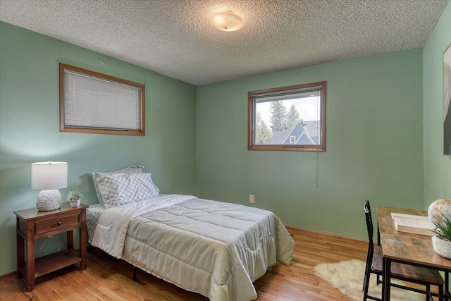 3308 W Kiernan Ave, Spokane, WA 99205 - bedroom featuring wood finished floors and a textured ceiling