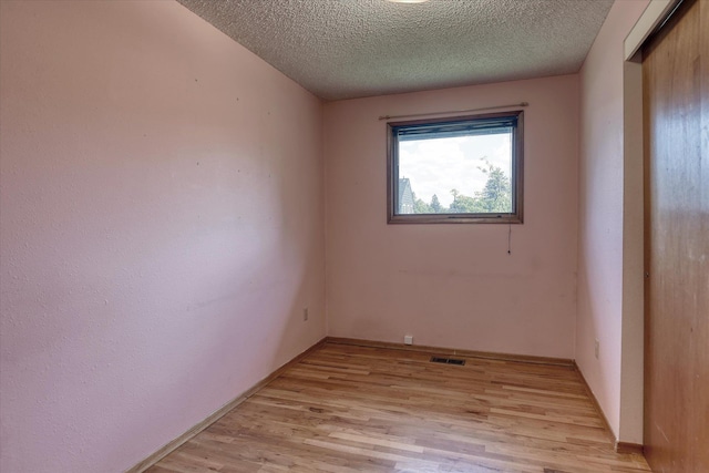 3308 W Kiernan Ave, Spokane, WA 99205 - unfurnished room featuring light wood-style flooring and a textured ceiling