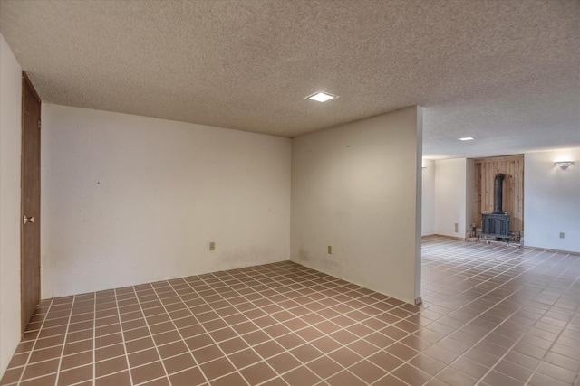3308 W Kiernan Ave, Spokane, WA 99205 - spare room featuring a wood stove and a textured ceiling