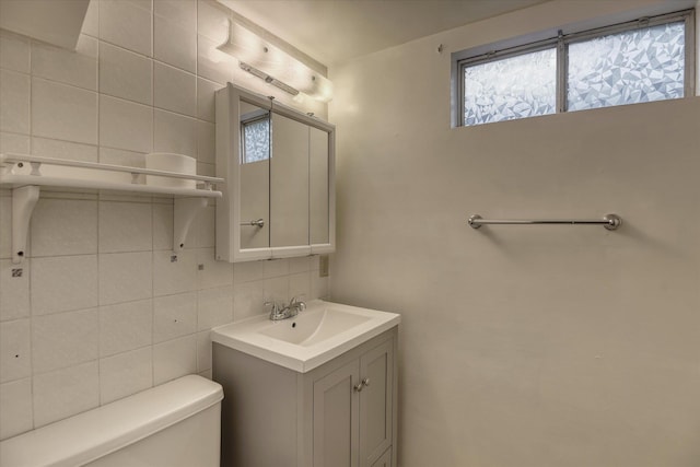 3308 W Kiernan Ave, Spokane, WA 99205 - bathroom with tile walls, vanity, decorative backsplash, and plenty of natural light