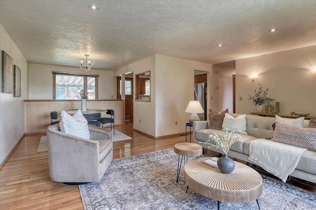 3308 W Kiernan Ave, Spokane, WA 99205 - living room with a chandelier, light wood finished floors, recessed lighting, and a textured ceiling