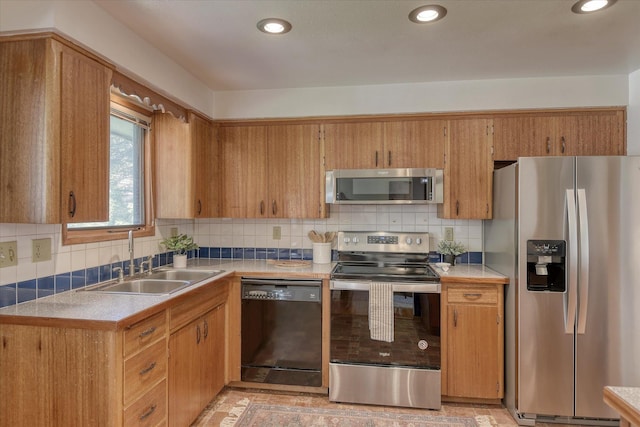 3308 W Kiernan Ave, Spokane, WA 99205 - kitchen with stainless steel appliances, backsplash, recessed lighting, light countertops, and brown cabinets