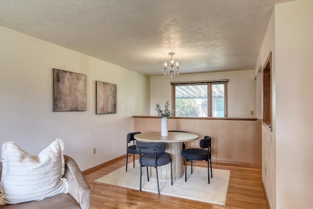 3308 W Kiernan Ave, Spokane, WA 99205 - dining space with wood finished floors, a chandelier, and a textured ceiling