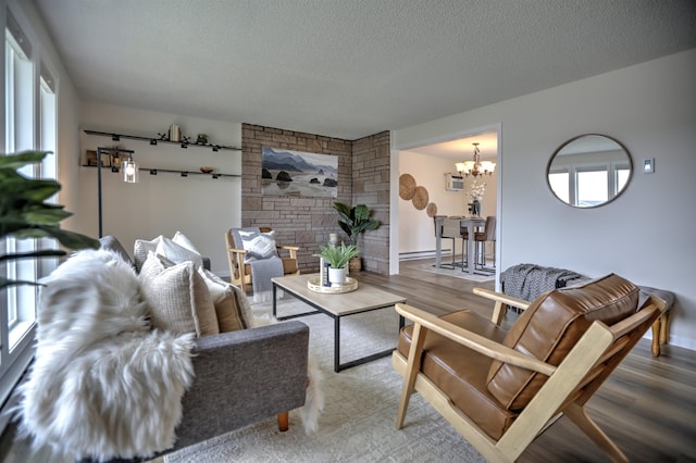 18306 E 3rd Ave, Greenacres, WA 99016 - living area with a chandelier, plenty of natural light, wood finished floors, and a textured ceiling