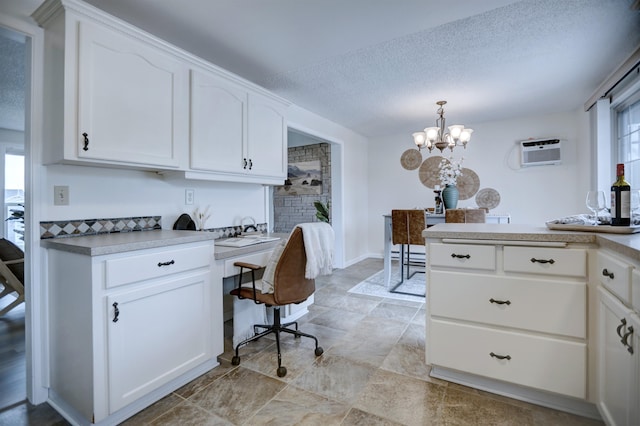 18306 E 3rd Ave, Greenacres, WA 99016 - kitchen featuring a chandelier, white cabinets, a textured ceiling, pendant lighting, and light countertops