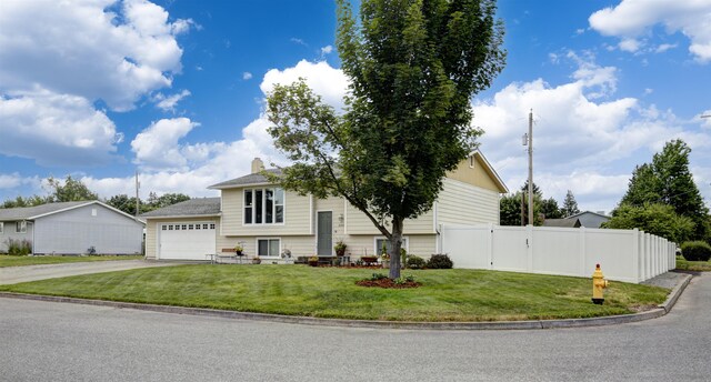 18306 E 3rd Ave, Greenacres, WA 99016 - raised ranch featuring asphalt driveway, a chimney, and a garage