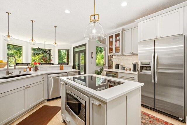 3742 W Cielo View Ct, Coeur D Alene, ID 83814 - kitchen featuring stainless steel appliances, backsplash, plenty of natural light, recessed lighting, and a textured ceiling