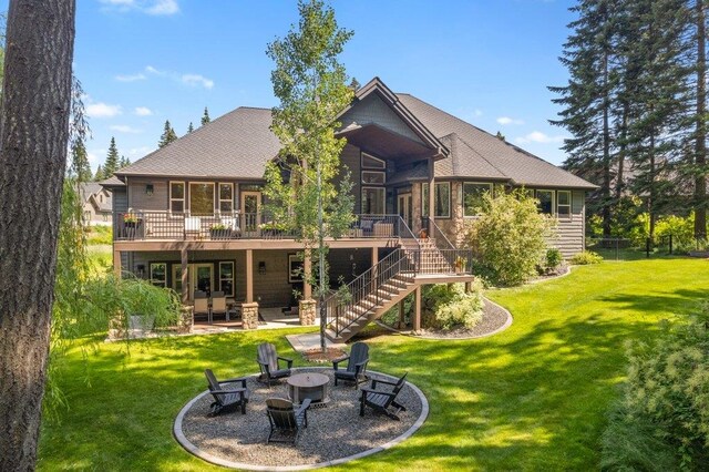 3742 W Cielo View Ct, Coeur D Alene, ID 83814 - rear view of property featuring an outdoor fire pit, a wooden deck, and a yard