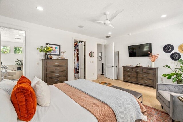 3742 W Cielo View Ct, Coeur D Alene, ID 83814 - bedroom with a walk in closet, light wood finished floors, recessed lighting, and ceiling fan