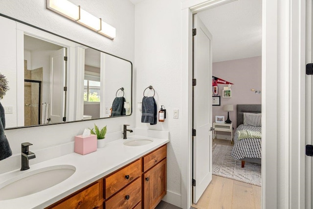 3742 W Cielo View Ct, Coeur D Alene, ID 83814 - bathroom with double vanity, ensuite bath, wood finished floors, and a stall shower