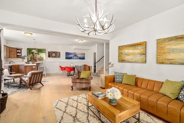 3742 W Cielo View Ct, Coeur D Alene, ID 83814 - living area with light wood-type flooring, a chandelier, and stairs