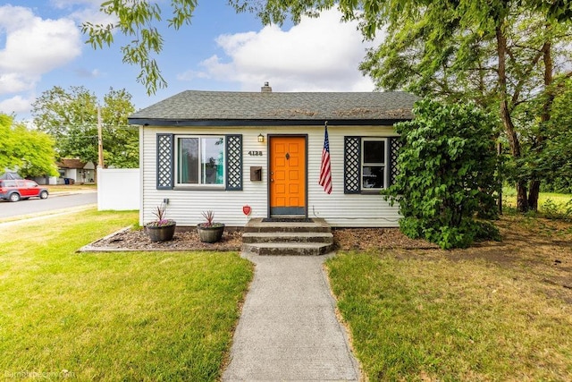 4128 E 22nd Ave, Spokane, WA 99223 - view of front of house featuring a front yard, a chimney, and roof with shingles