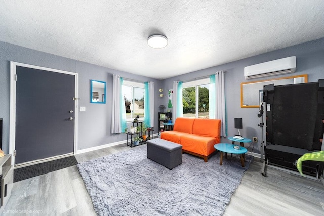 4128 E 22nd Ave, Spokane, WA 99223 - living area featuring a wall mounted air conditioner, wood finished floors, and a textured ceiling