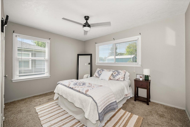 3623 W Longfellow Ave, Spokane, WA 99205 - bedroom with multiple windows, light colored carpet, and a ceiling fan