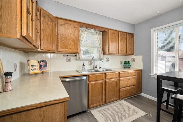 3623 W Longfellow Ave, Spokane, WA 99205 - kitchen featuring stainless steel dishwasher, light countertops, brown cabinetry, and backsplash