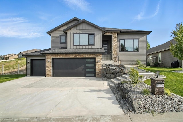 11208 E Rimrock Ln, Spokane Valley, WA 99206 - view of front facade featuring board and batten siding, concrete driveway, stone siding, an attached garage, and a front yard
