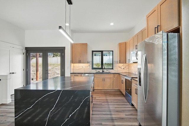 11208 E Rimrock Ln, Spokane Valley, WA 99206 - kitchen featuring appliances with stainless steel finishes, light brown cabinetry, dark wood finished floors, french doors, and tasteful backsplash