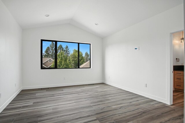 11208 E Rimrock Ln, Spokane Valley, WA 99206 - spare room featuring lofted ceiling and wood finished floors