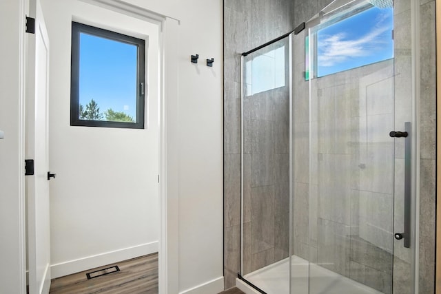 11208 E Rimrock Ln, Spokane Valley, WA 99206 - bathroom with plenty of natural light, a stall shower, and wood finished floors