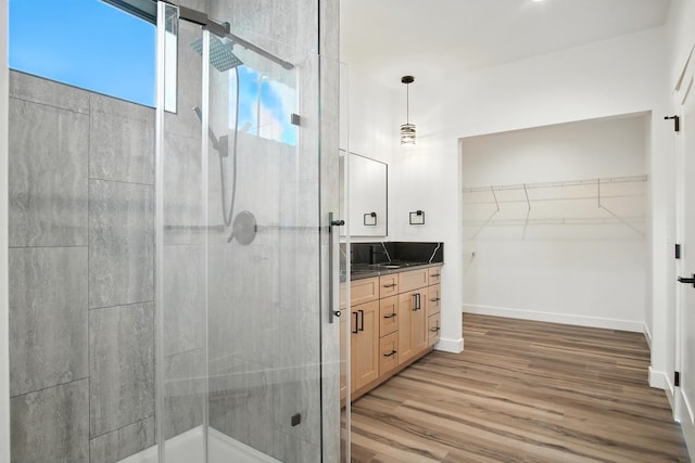 11208 E Rimrock Ln, Spokane Valley, WA 99206 - full bathroom featuring a shower stall, vanity, a walk in closet, and wood finished floors