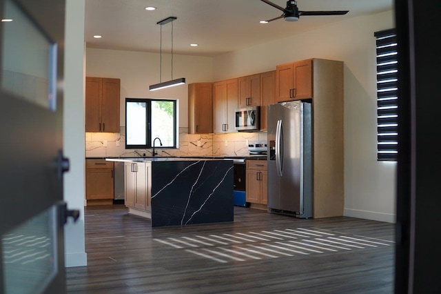 11208 E Rimrock Ln, Spokane Valley, WA 99206 - kitchen featuring appliances with stainless steel finishes, a ceiling fan, decorative backsplash, dark wood-type flooring, and recessed lighting