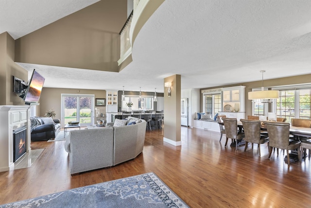 2804 W Johannsen Rd, Spokane, WA 99208 - living room featuring a fireplace with flush hearth, wood finished floors, and a textured ceiling