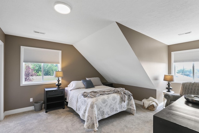 2804 W Johannsen Rd, Spokane, WA 99208 - bedroom with multiple windows, light carpet, and lofted ceiling