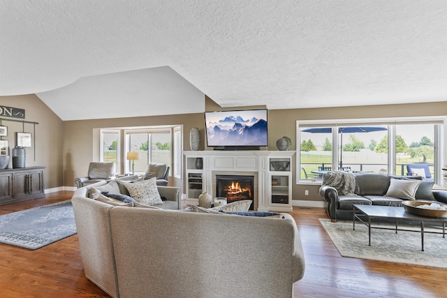 2804 W Johannsen Rd, Spokane, WA 99208 - living area with a warm lit fireplace, wood finished floors, and a textured ceiling