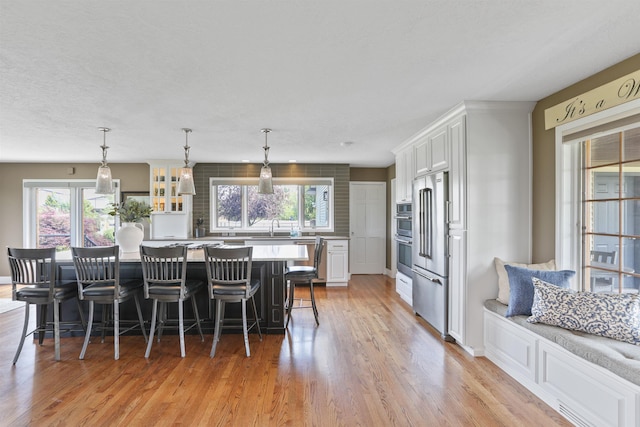 2804 W Johannsen Rd, Spokane, WA 99208 - kitchen with white cabinetry, light countertops, light wood-type flooring, and a center island