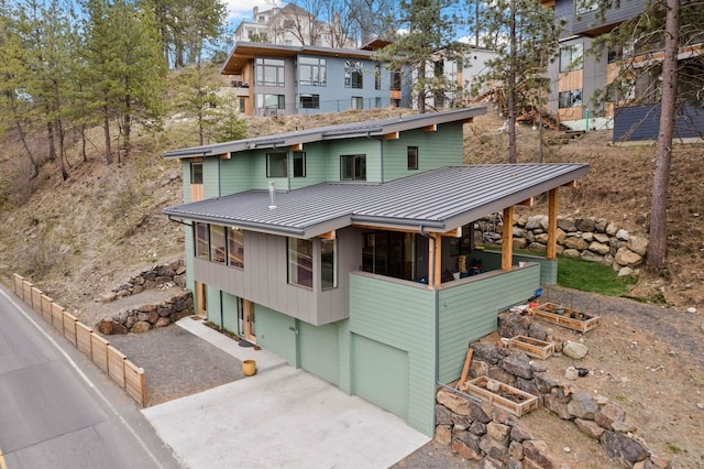 2435 W Riverside Ave, Spokane, WA 99201 - view of front of property with a metal roof, an attached garage, a standing seam roof, and driveway