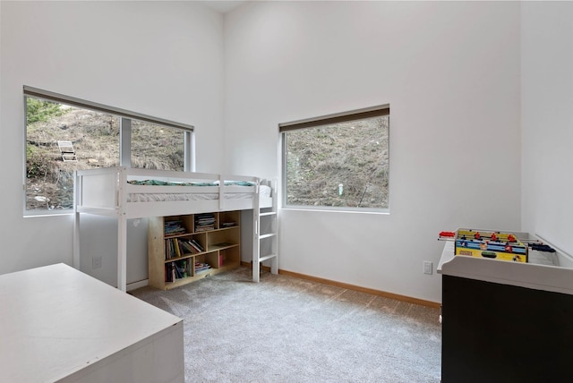 2435 W Riverside Ave, Spokane, WA 99201 - carpeted bedroom featuring baseboards and a high ceiling
