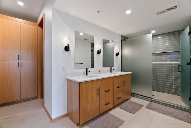 2435 W Riverside Ave, Spokane, WA 99201 - bathroom featuring double vanity, recessed lighting, a shower stall, and tile patterned flooring