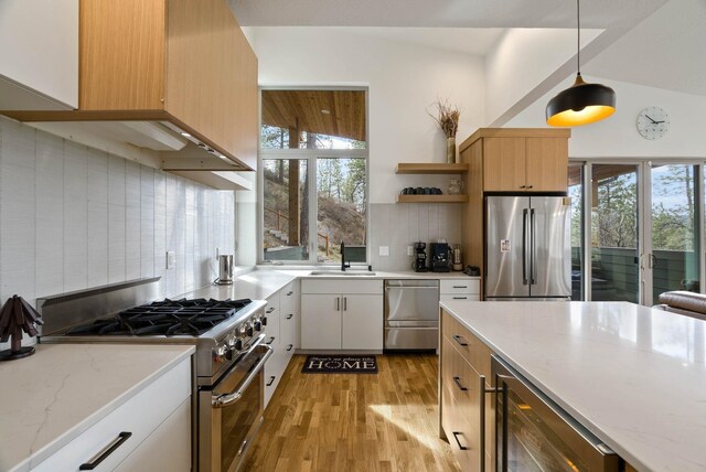 2435 W Riverside Ave, Spokane, WA 99201 - kitchen featuring appliances with stainless steel finishes, wine cooler, decorative backsplash, light wood-style flooring, and open shelves