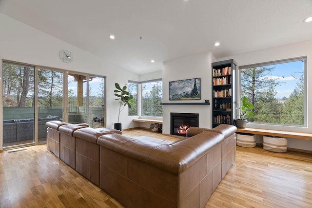 2435 W Riverside Ave, Spokane, WA 99201 - living area featuring a glass covered fireplace, healthy amount of natural light, light wood-style flooring, recessed lighting, and lofted ceiling
