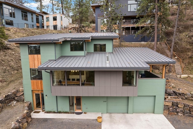 2435 W Riverside Ave, Spokane, WA 99201 - view of front of property with concrete driveway, a garage, and a metal roof