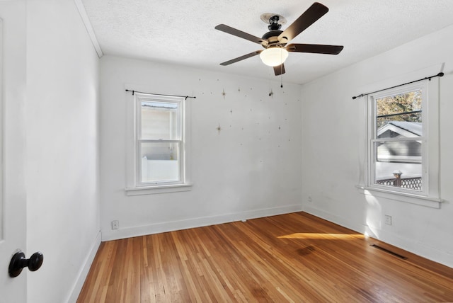 107 E 29th Ave, Spokane, WA 99203 - empty room with light wood finished floors, a textured ceiling, and a ceiling fan