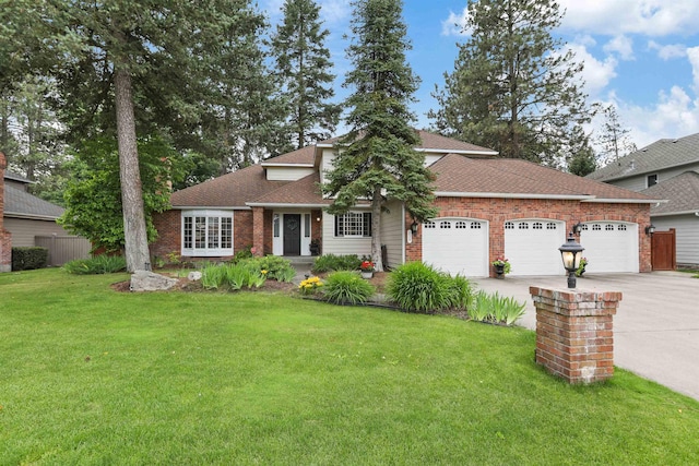 339 W Wilson Ave, Spokane, WA 99208 - view of front of property with an attached garage, brick siding, a front yard, and driveway