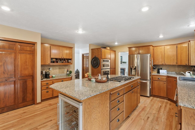 339 W Wilson Ave, Spokane, WA 99208 - kitchen featuring wine cooler, stainless steel appliances, a center island, light wood-style floors, and recessed lighting