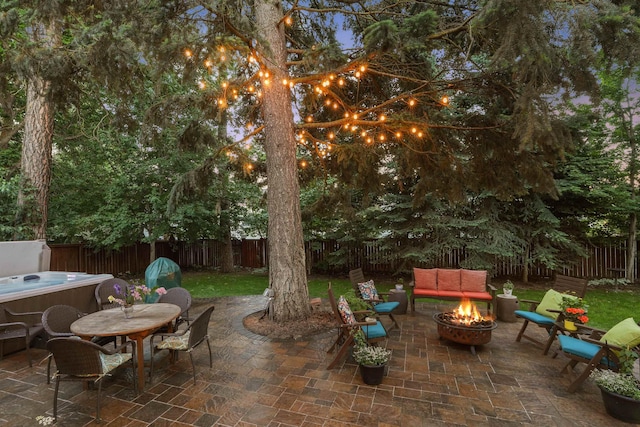 339 W Wilson Ave, Spokane, WA 99208 - fenced backyard featuring a fire pit, a hot tub, a patio area, and outdoor dining space